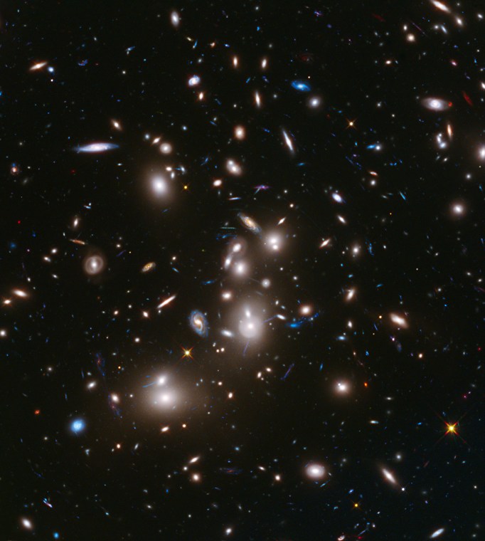 The immense gravity in this foreground galaxy cluster, Abell 2744, warps space to brighten and magnify images of far-more-distant background galaxies as they looked over 12 billion years ago, not long after the big bang. This is the first of the Frontier Fields to be imaged.