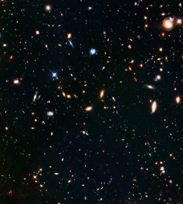 Abell S1063 Parallel Field - This deep galaxy image is of a random field located near the galaxy cluster Abell S1063. As part of the Frontier Fields Project, while one of Hubble's instruments was observing the cluster, another instrument observed this field in parallel. These deep fields provide invaluable images and statistics about galaxies stretching toward the edge of the observable universe.